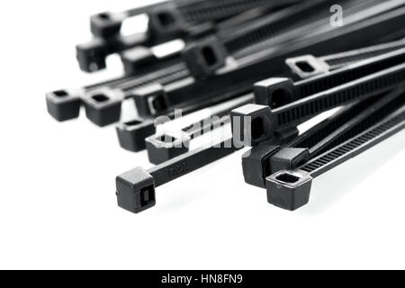 heap of black cable ties on white background Stock Photo