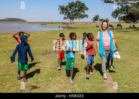 Local Ethiopian Boys Chatting To A Female Tourist, Lake Ziway, Ethiopia Stock Photo