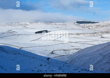 Snow covered fields, dry stone walls and field barn at Darnbrook near Littondale, Yorkshire Dales National Park, North Yorkshire, UK