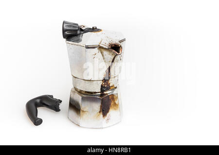 Vintage Moka pot forgotten on the fire. Burned with in molten plastic components. Stock Photo