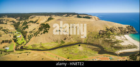 Aerial panorama of Middle River flowing among yellow hills on Kangaroo Island, South Australia Stock Photo