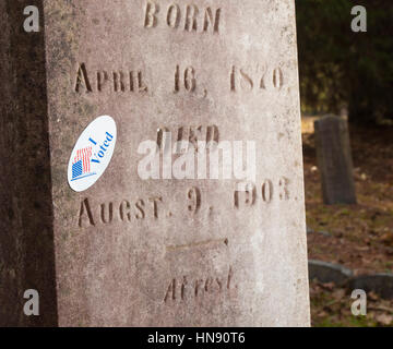 Grave stone that has an I voted sticker on it Stock Photo