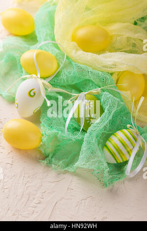 Green and yellow Easter eggs on a light background Stock Photo