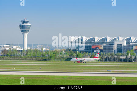 Munich, Germany - May 6, 2016: Munich international airport panoramic view with passenger airplane of Austrian Airlines taxiing to runway Stock Photo