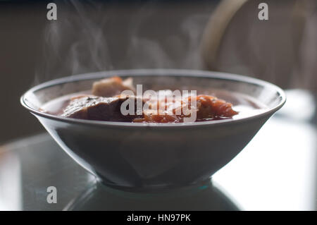 Borscht ukrainian national cuisine on the table in deep plate with steam Stock Photo