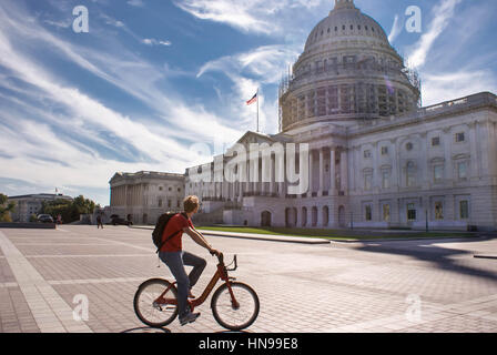 Washington DC, USA - September 27, 2014: Tourist on a bike pause to look at the Capitol Building in Washington DC, USA Stock Photo