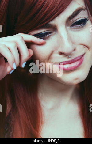 Young redhead woman crying Stock Photo