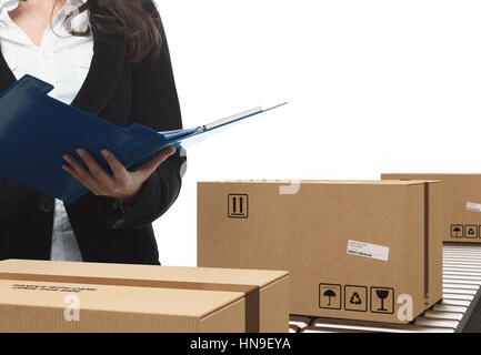 Businesswoman checks boxes on conveyor roller Stock Photo