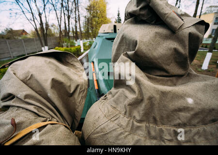 Two Unidentified Re-enactors Dressed As Russian Soviet Infantry Soldiers Of World War II Pushing Stalled Armoured Soviet Scout Car Ba-64 In Street Of  Stock Photo