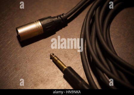 Close up image of a a rolled up cable with jacks. Stock Photo