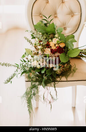 Beautiful french wedding bouquet on an elegant white chair Stock Photo