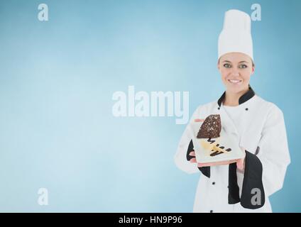 Digital composite of Chef with cake slice against blue background Stock Photo