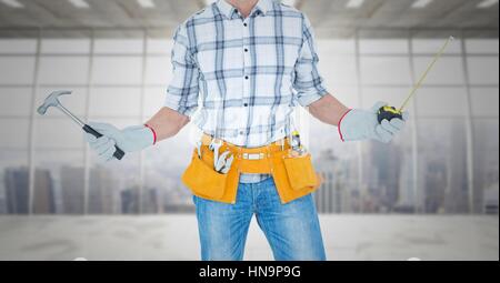 Digital composite of Carpenter with hammer and measuring tape against window Stock Photo