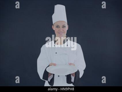 Digital composite of Chef with plate against navy background Stock Photo