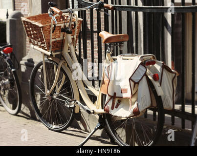 White bike with brown leather accesories parked in one of Amsterdam's streets. Stock Photo