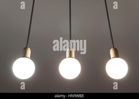 LED white bulbs hanging from the ceiling. Illumination technology. Stock Photo