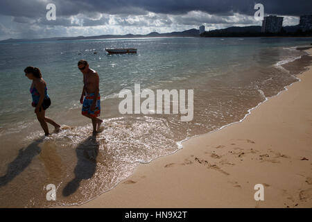 Older couple walking on tropical beach, Luquillo, Puerto Rico Stock Photo