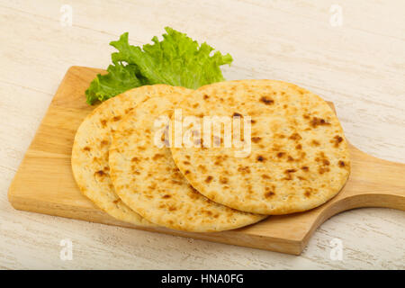 Pita bread with salad over wood background Stock Photo