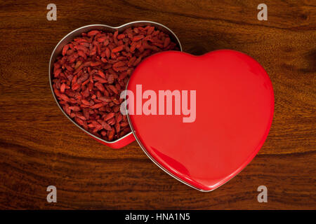 Goji berries in a heart-shaped box Stock Photo