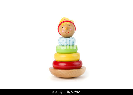 Pyramid build from colored wooden rings with a king head on top. Toy for babies and toddlers to joyfully learn mechanical skills and colors. Studio sh Stock Photo