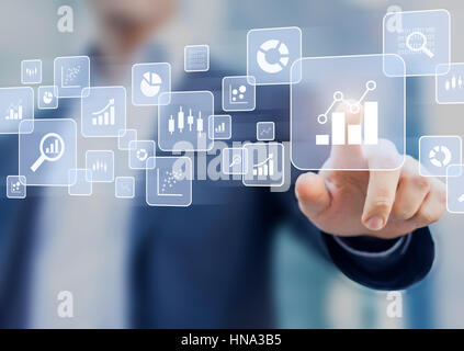 Big data analytics and business intelligence (BI) concept with chart and graph icons on a digital screen interface and a businessman in background Stock Photo