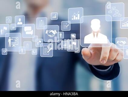 Human resources (HR) management concept on a virtual screen interface with a business person in background and icons about recruiting, technology data Stock Photo