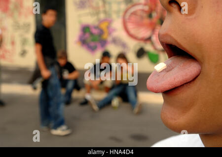 Teenagers take drug - drug tablet on tongue    Credit  © Luigi Innamorati/Sintesi/Alamy Stock Photo *** Local Caption ***