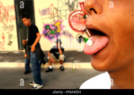 Teenagers take drug - drug tablet on tongue    Credit  © Luigi Innamorati/Sintesi/Alamy Stock Photo
