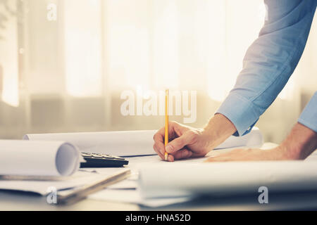 architect working with blueprints in office Stock Photo