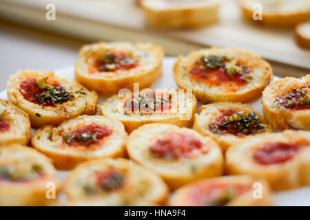 Fresh baked light and delicious bruschetta appetizers with tomato amd oregano. Selective focus Stock Photo