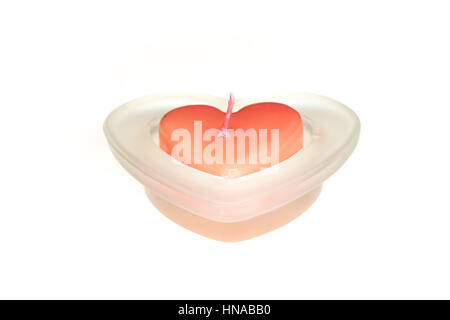 read heart shape candle in glass pot isolated on white background Stock Photo