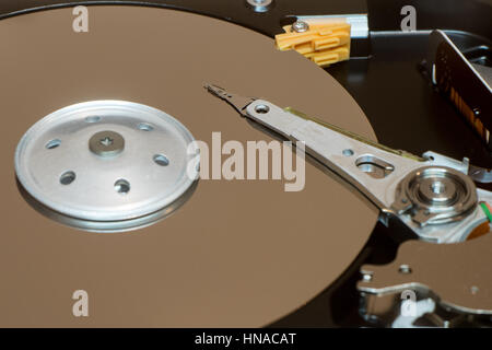 Close up inside of computer disk drive HDD . Detail of writing and reading head on acuator arm and axis, spindle and platters Stock Photo