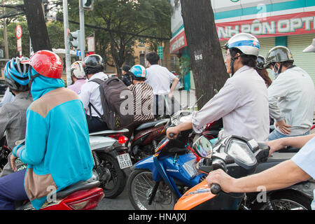 Scooter motorbike riders travelling through Ho Chi Minh city in Vietnam,Asia Stock Photo