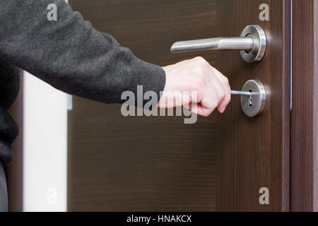 hand unlock house door Stock Photo