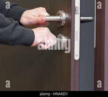 hand unlock house door Stock Photo
