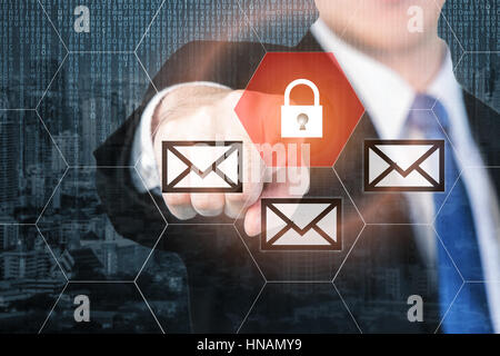 Businessman pressing e-mail security button on virtual screens for internet and e-mail security. Business, technology, internet and virtual reality co Stock Photo