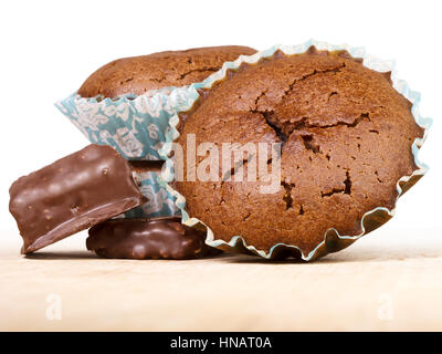 Muffin and chocolate sweets. Fresh baked cakes in paper baking dish with cracked surface. Stock Photo