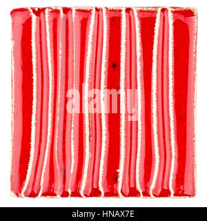 Red lined handmade glazed ceramic tile isolated on white background Stock Photo