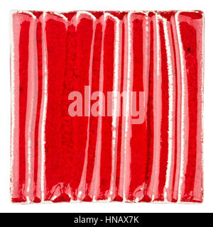 Red lined handmade glazed ceramic tile isolated on white background Stock Photo