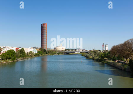 Seville, Spain - May 1, 2016: View of Guadalquivir river with Sevilla Tower, Torre Triana, Schindler Tower and Puente del Cachorro at Puerto Triana qu Stock Photo