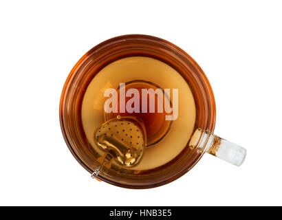 Cup of tea and tea strainer with heart shape. Upper view. Stock Photo