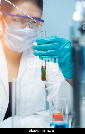 Young scientist handling chemical agents in laboratory Stock Photo
