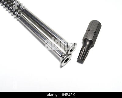 Two torx screws and a bit on a white background Stock Photo