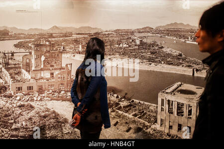 visitors looks a photo of Hiroshima after the atomic bomb explosion. Inside the Hiroshima Peace Memorial Museum, Hiroshima, Japan Stock Photo