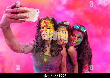 Image of A Happy Young Indian Girl with Holi Colors On Her Taking Selfie  With Smart Phone-PT594926-Picxy