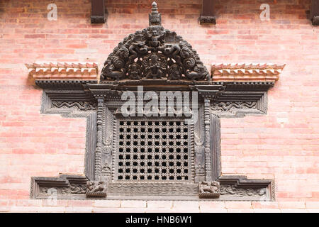 Carved wooden window with lattice work in the traditional Nepalese style of an old building in Bhaktapur, Kathmandu Stock Photo