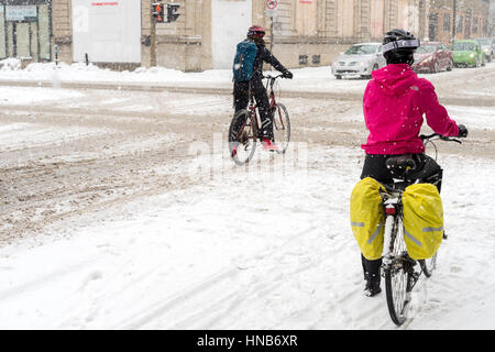 Montreal, CA, 7th March 2016. Two people riding bikes during snow storm Stock Photo