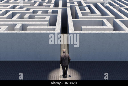 Business man walking to challenge an endless maze, conceptual image representing business strategy, complex problem encounter and find solution Stock Photo