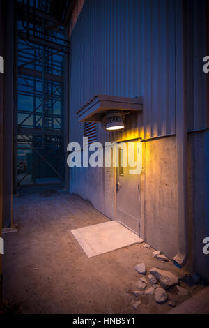 Light Over Industrial Doorway At Night, Arizona USA Stock Photo