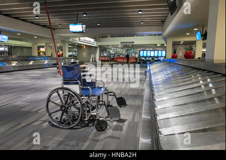 Empty Wheelchair in Airport Baggage Area Stock Photo